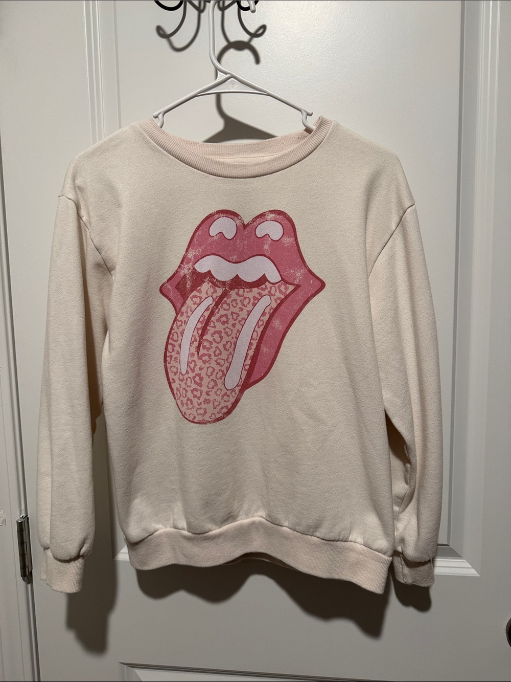 the Rolling Stones Cream Sweatshirt with Pink Leopard Tongue Graphic